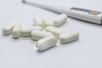 Fototapeta na wymiar White long health drug pills on white background