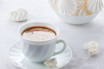 A cup of fresh coffee with cream and a gentle, airy Bizet
