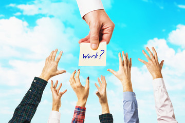 Lots of hands against the sky. People are drawn to the opportunity to get a job. Concept on...
