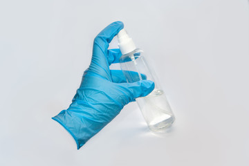 Spray disinfect liquid, hand in blue glove on white