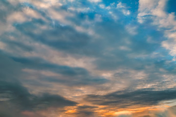 The sky at sunset. Cumulus clouds lit by the rays of the setting sun.