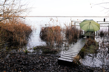 wooden pontoon pier with fisherman equipment at sunrise lake medoc of Maubuisson Carcans France