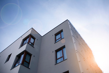 Modern apartment building flat estate concept. Outdoor residential facility at sunset and sunrise.