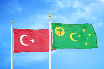 Turkey and Cocos Keeling Islands two flags on flagpoles and blue cloudy sky