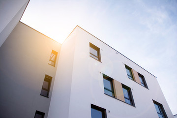 Modern apartment building flat estate concept. Outdoor residential facility at sunset and sunrise.