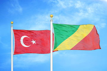 Turkey and Congo two flags on flagpoles and blue cloudy sky