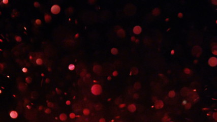 Luxury Glitter bokeh out of focus glittering particles sparks splash in camera on black background fashion photo for your special events projects.
