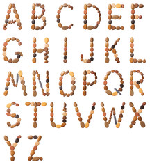 English alphabet made of sea small pebbles isolated on white background