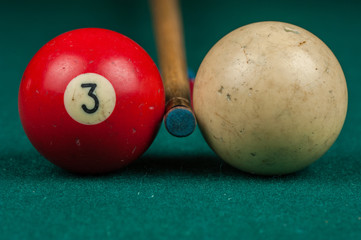 Billiards balls and cue on billiards table. Billiard sport concept