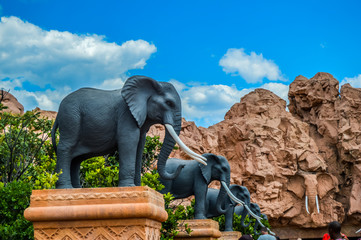 Entrance of The Palace / Lost City /Sun City with stone statues under blue and cloudy sky