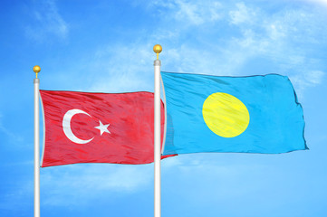 Turkey and Palau two flags on flagpoles and blue cloudy sky