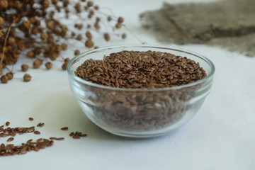 Flax seeds in a glass container, close-up