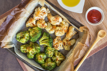 Baked broccoli and cauliflower with spices on parchment paper. Vegan healthy diet dish