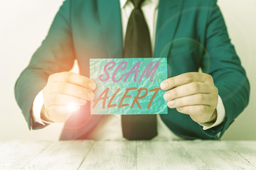 Handwriting text Scam Alert. Conceptual photo unsolicited email that claims the prospect of a...