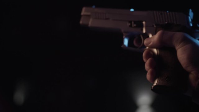 Stock video footage firearm put a clip in the gun