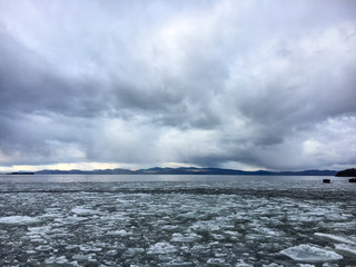 Sunset over icy and stormy Lake Champlain