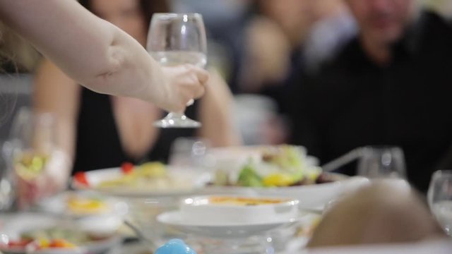 Festive table in a restaurant, people have dinner, celebration background