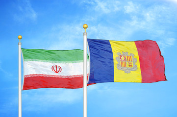 Iran and Andorra  two flags on flagpoles and blue cloudy sky