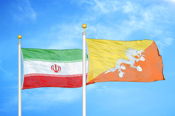 Iran and Bhutan  two flags on flagpoles and blue cloudy sky