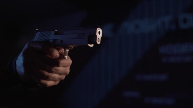 Stock video footage firearm firing of a gun in the dash