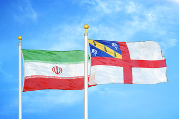 Iran and Herm two flags on flagpoles and blue cloudy sky