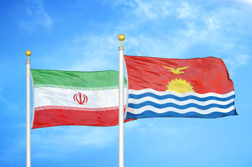 Iran and Kiribati two flags on flagpoles and blue cloudy sky
