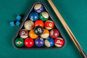 Billiards balls and cue on billiards table. Billiard sport concept