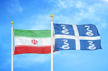 Iran and Martinique snake two flags on flagpoles and blue cloudy sky