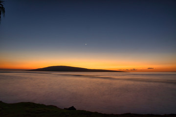 Sunset long exposure of Lanai at sunrise with moon setting.