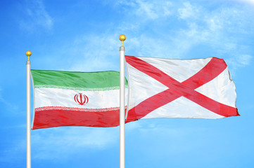 Iran and Northern Ireland two flags on flagpoles and blue cloudy sky