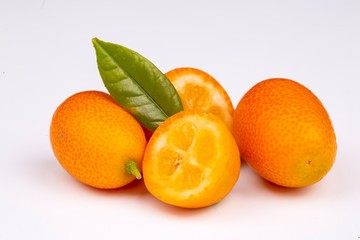 Cumquat or kumquat with leaf isolated on white background close up