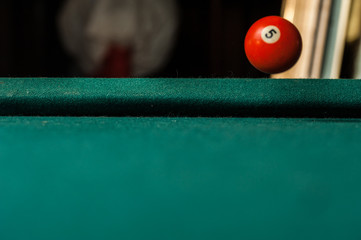 Billiards balls and cue on billiards table. Billiard sport concept.Ball in motion