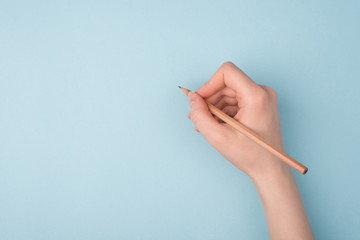 Top close up pov above overhead view photo of hand holding wooden pencil starting to draw a picture...
