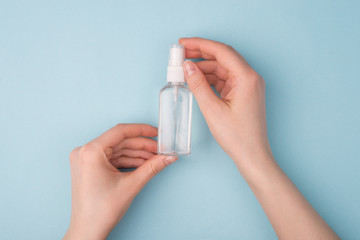 Pov top overhead above close up view photo of girl holding small bottle with transparent isolated over blue background with copy empty blank space