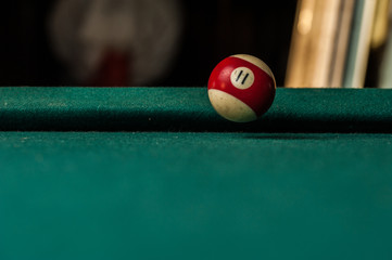 Billiards balls and cue on billiards table. Billiard sport concept.Ball in motion