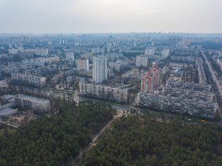 Fototapeta na wymiar The outskirts of Kiev, near coniferous forest. Aerial drone view.