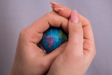A little globe in women 's hands