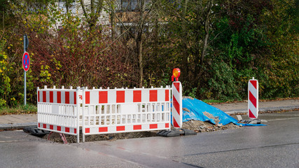 Empty deserted road. Red and white colored street barrier, repair of roads, 16:9 panoramic format