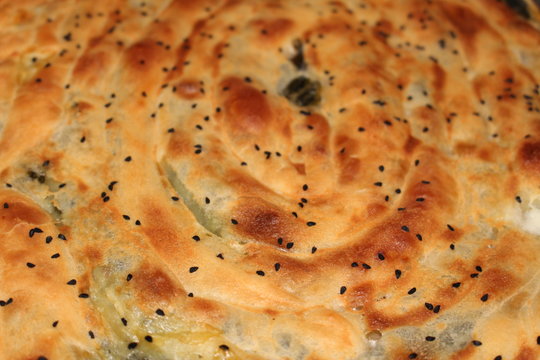  Famous Turkish pastry (Turkish borek) with spinach and black cumin on top.