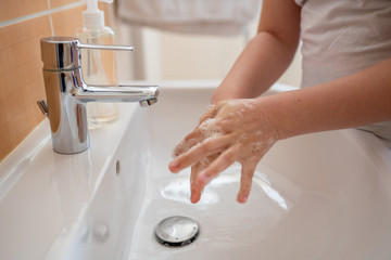 washing hands with foaming antibacterial soap applying hand disinfectant