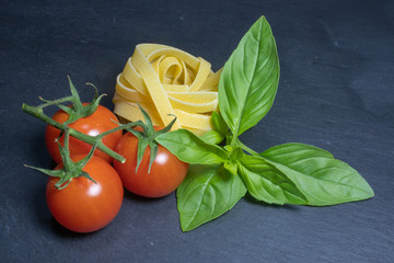 Raw ingredients for tomato and basil pasta