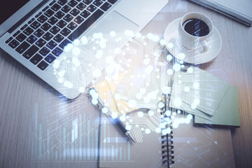 Double exposure of brain drawing hologram over topview work table background with computer. Concept of big data.