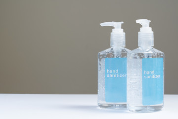 Two hand sanitizer in plastic bottle with blue label