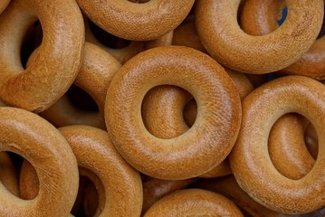 brown background of small round bagels in a heap