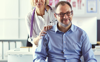 Serious medical team using a laptop in a bright office