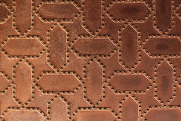 Metal door pattern of Nasrid Palaces (Palacios Nazaries) at the historical Alhambra Palace complex in Granada, Andalusia, Spain.