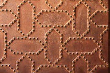 Metal door pattern of Nasrid Palaces (Palacios Nazaries) at the historical Alhambra Palace complex in Granada, Andalusia, Spain.
