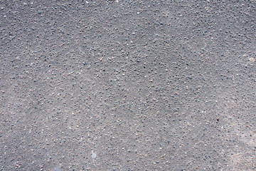Texture of black asphalt, bitumen and stones, small inclusions