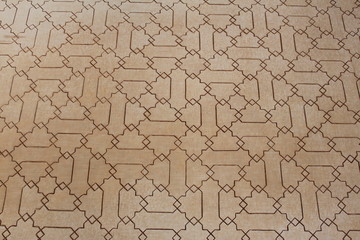 Historical Arabic wall pattern at Nasrid Palaces (Palacios Nazaries) at Alhambra Palace and fortress complex in Granada, Andalusia, Spain.