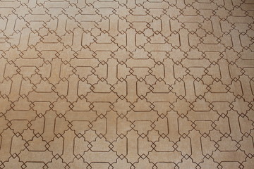 Historical Arabic wall pattern at Nasrid Palaces (Palacios Nazaries) at Alhambra Palace and fortress complex in Granada, Andalusia, Spain.